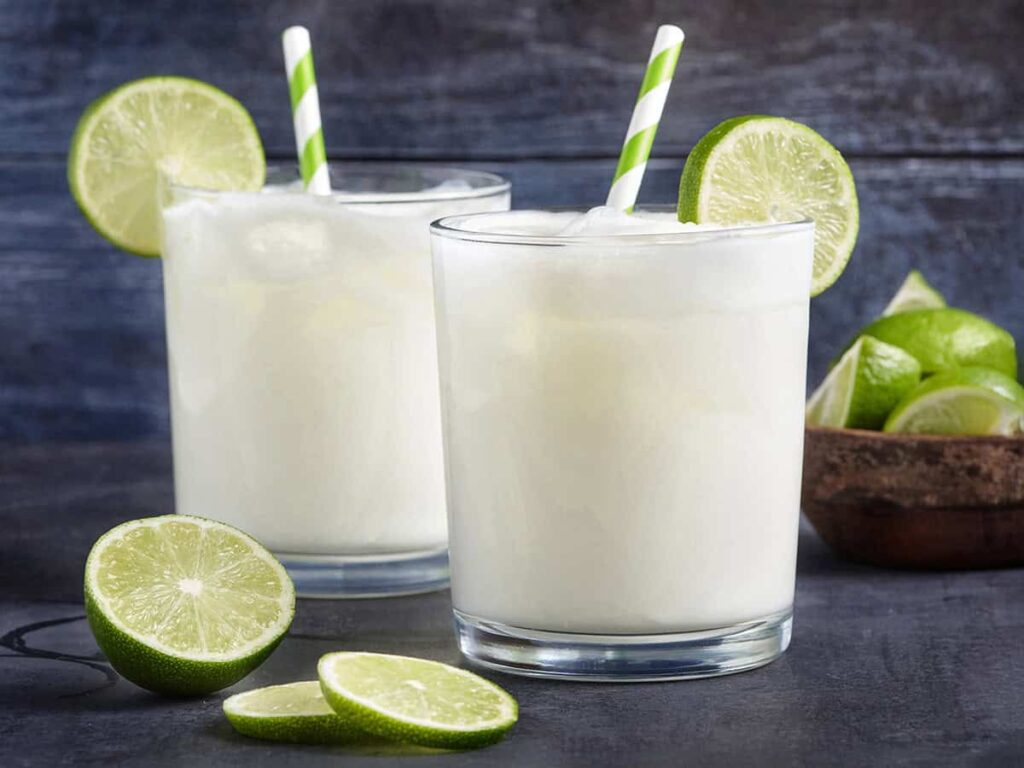 Side view of two glasses of homemade Brazilian lemonade.